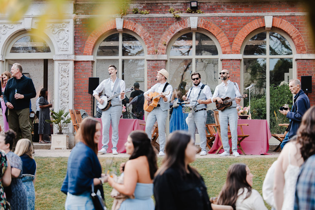 Live roaming band performing at a wedding rehearsal dinner at Ashridge House Hertfordshire