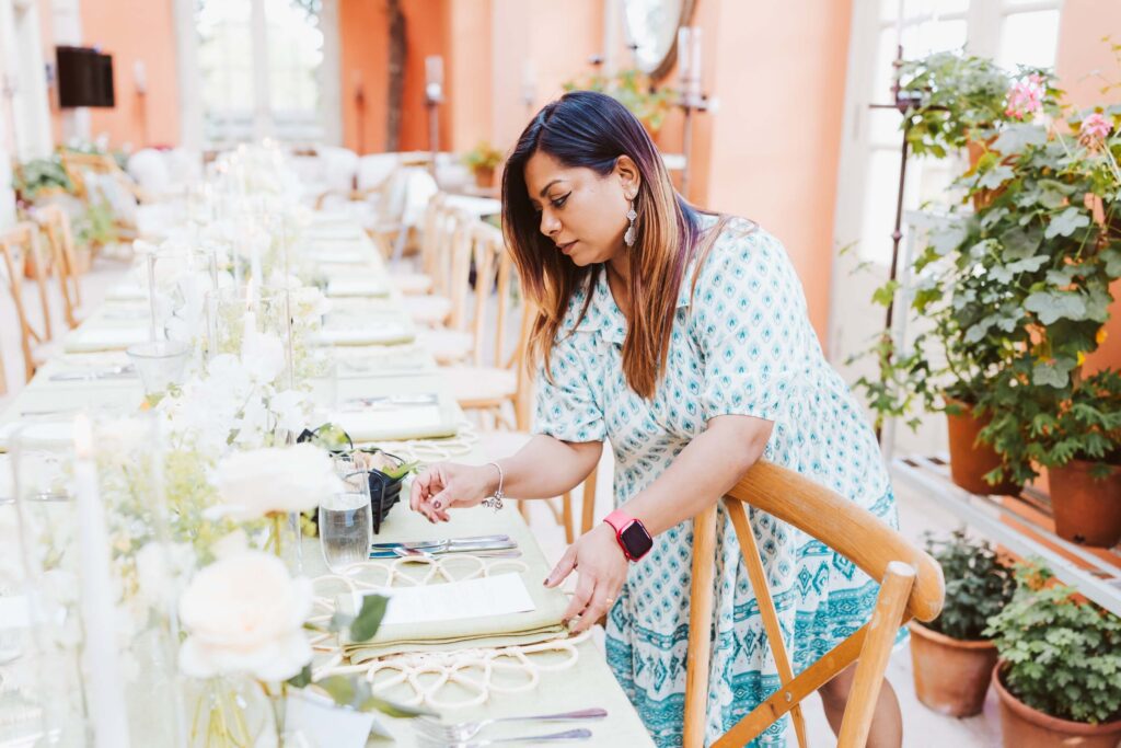 Luxury wedding coordinator Nalini Raman styling a wedding breakfast tablescape for an on-the-day coordination wedding