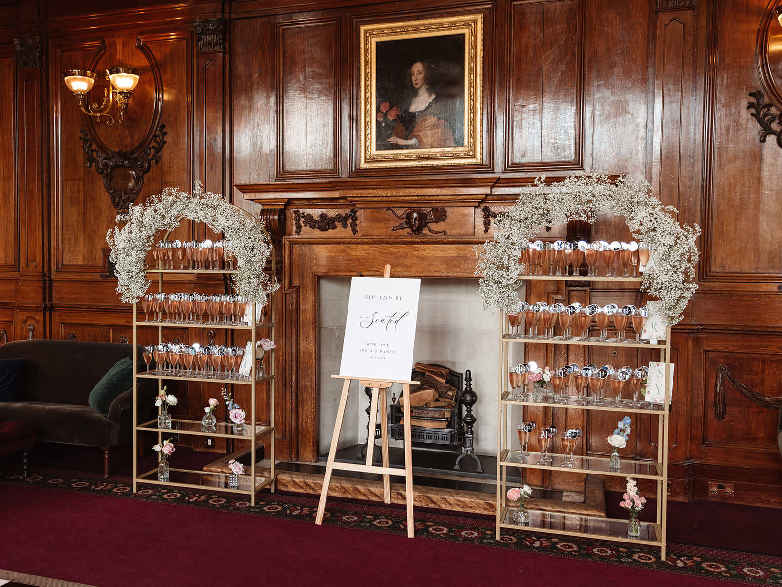 Wedding coordinator Ashridge House Hertfordshire — luxury cocktail hour champagne display with gypsophila arches and personalised seating plan by Knots and Nuptials